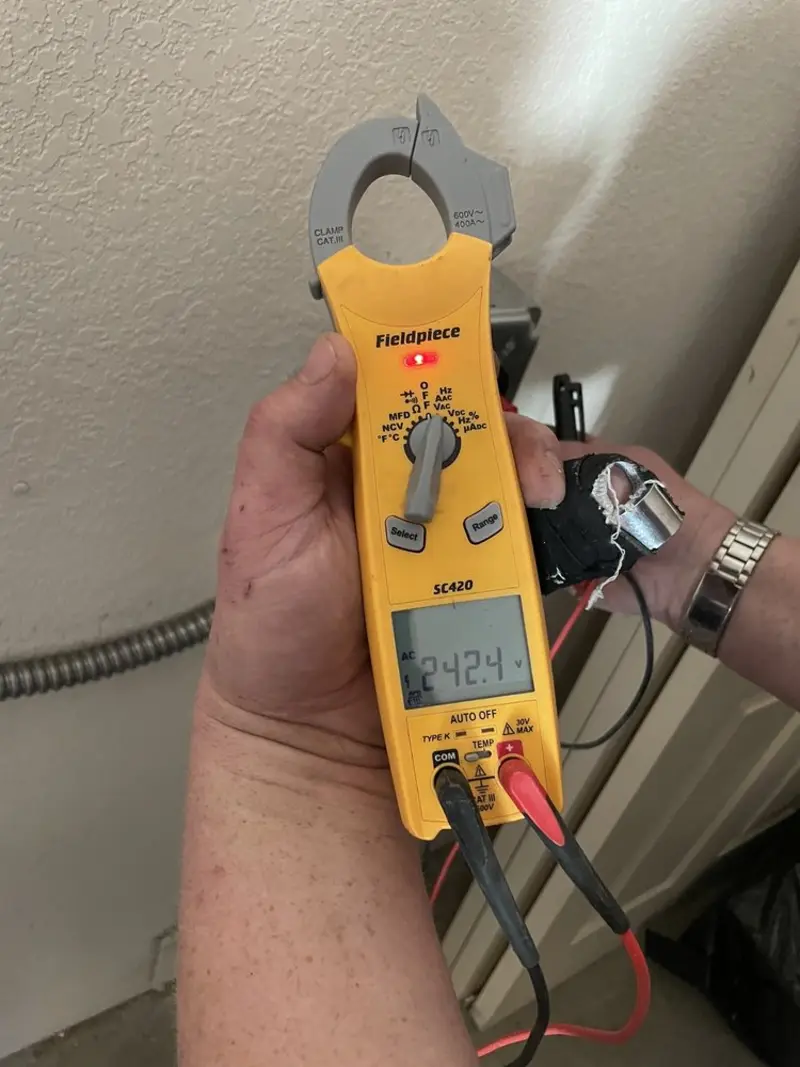 Voltage testing with clamp meter during Recessed Lighting Installation in Burleson